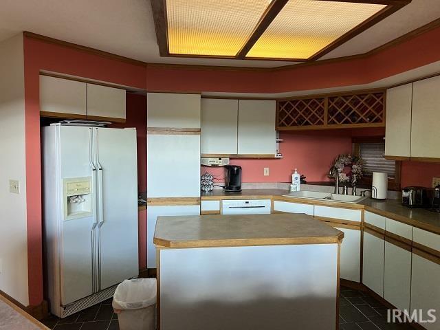 720 Ln 800 Snow Lk, Fremont, IN 46737 - kitchen featuring white appliances, a sink, dark tile patterned floors, and a center island