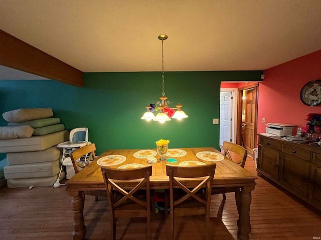 dining room with beam ceiling and dark wood-type flooring