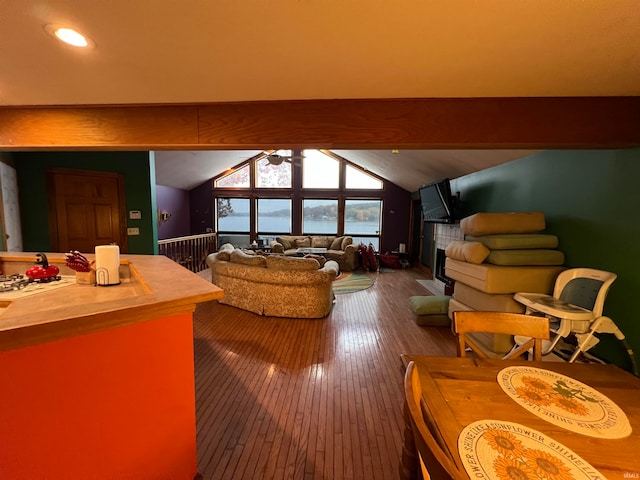 living room with lofted ceiling with beams, hardwood / wood-style flooring, and ceiling fan