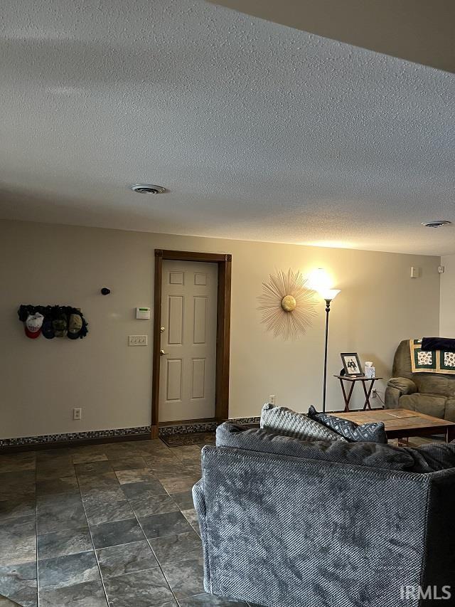 720 Ln 800 Snow Lk, Fremont, IN 46737 - living room with a textured ceiling