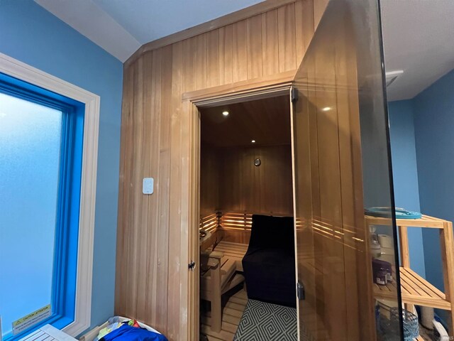 view of sauna / steam room featuring wood walls