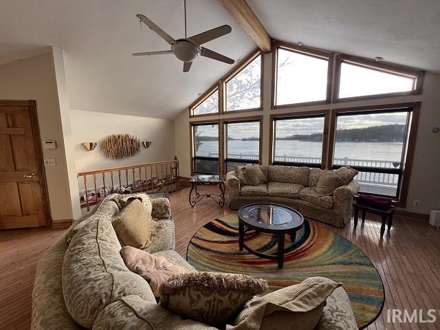 720 Ln 800 Snow Lk, Fremont, IN 46737 - living room featuring a ceiling fan, healthy amount of natural light, beamed ceiling, baseboards, and high vaulted ceiling