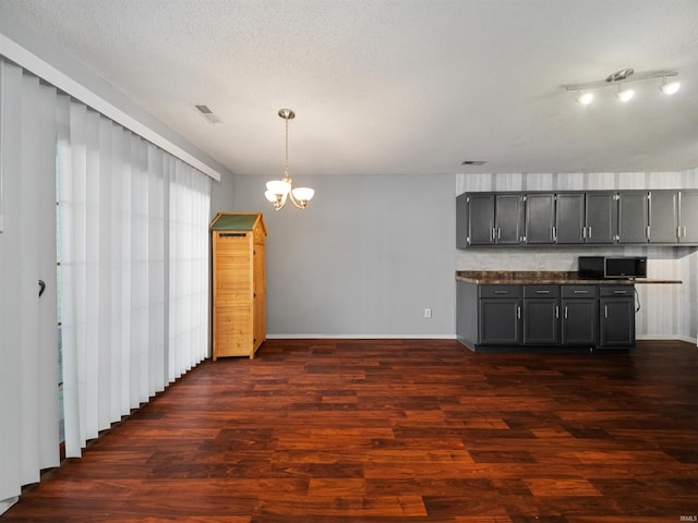 kitchen featuring an inviting chandelier, dark hardwood / wood-style floors, and gray cabinetry