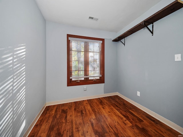 empty room with hardwood / wood-style floors