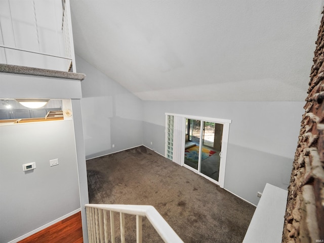 additional living space featuring vaulted ceiling and dark hardwood / wood-style floors