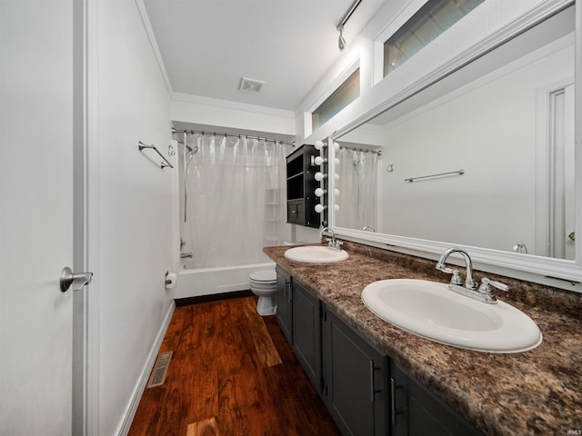 full bathroom featuring vanity, shower / bath combo, hardwood / wood-style flooring, and toilet