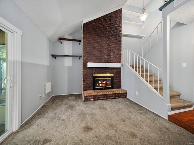 unfurnished living room featuring high vaulted ceiling, a textured ceiling, a fireplace, and carpet floors