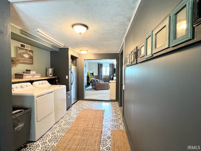 3810 E 100 N, Flora, IN 46929 - washroom featuring a textured ceiling, ornamental molding, washer and dryer, visible vents, and laundry area