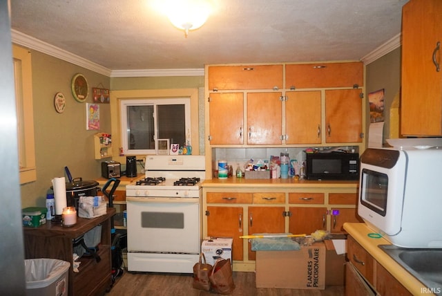 kitchen with white appliances, crown molding, dark hardwood / wood-style flooring, and sink