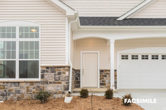 view of exterior entry with a garage