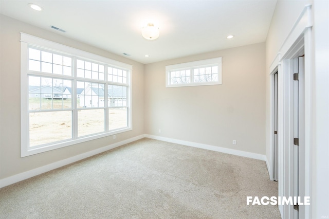 unfurnished room with light colored carpet