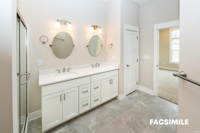 bathroom with vanity and a shower with door