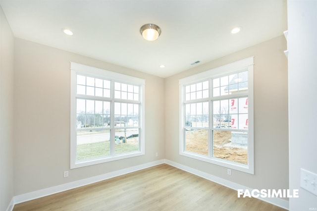 spare room with light hardwood / wood-style flooring