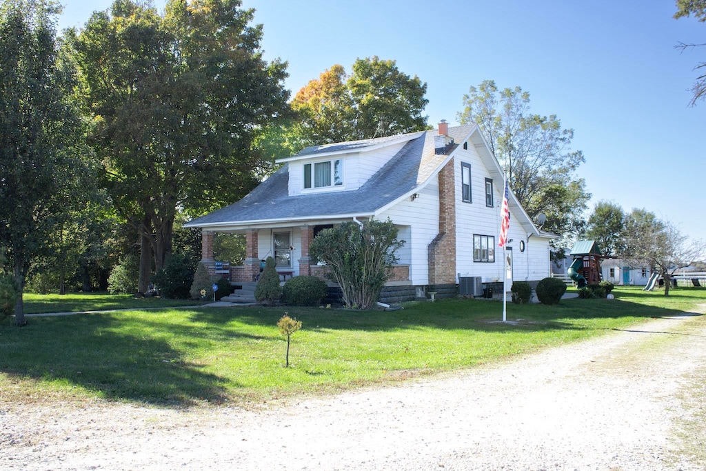 view of front facade with central AC and a front lawn