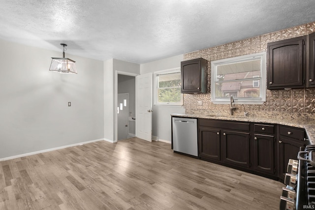 kitchen with light hardwood / wood-style flooring, sink, stainless steel dishwasher, and decorative light fixtures