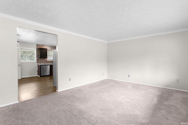 empty room featuring ornamental molding, a textured ceiling, and dark carpet