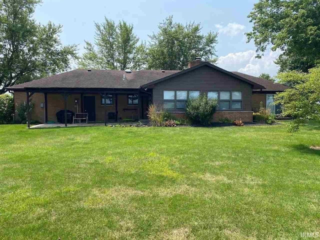 rear view of property featuring a yard