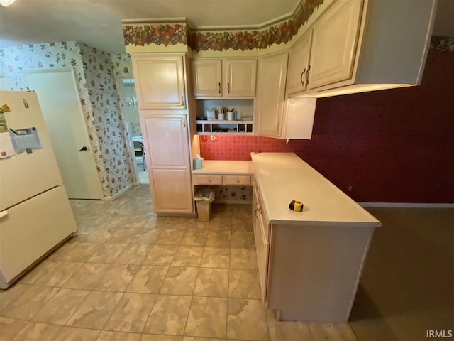 kitchen featuring white fridge and kitchen peninsula