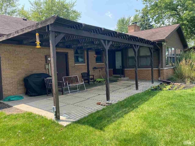 rear view of house with a yard and a pergola