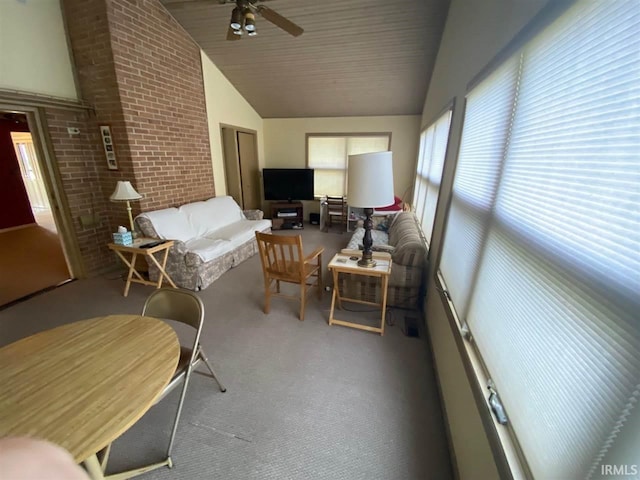 sunroom with ceiling fan and vaulted ceiling