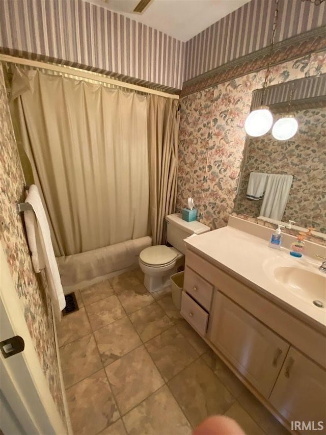 full bathroom featuring vanity, toilet, tile patterned floors, and shower / tub combo with curtain