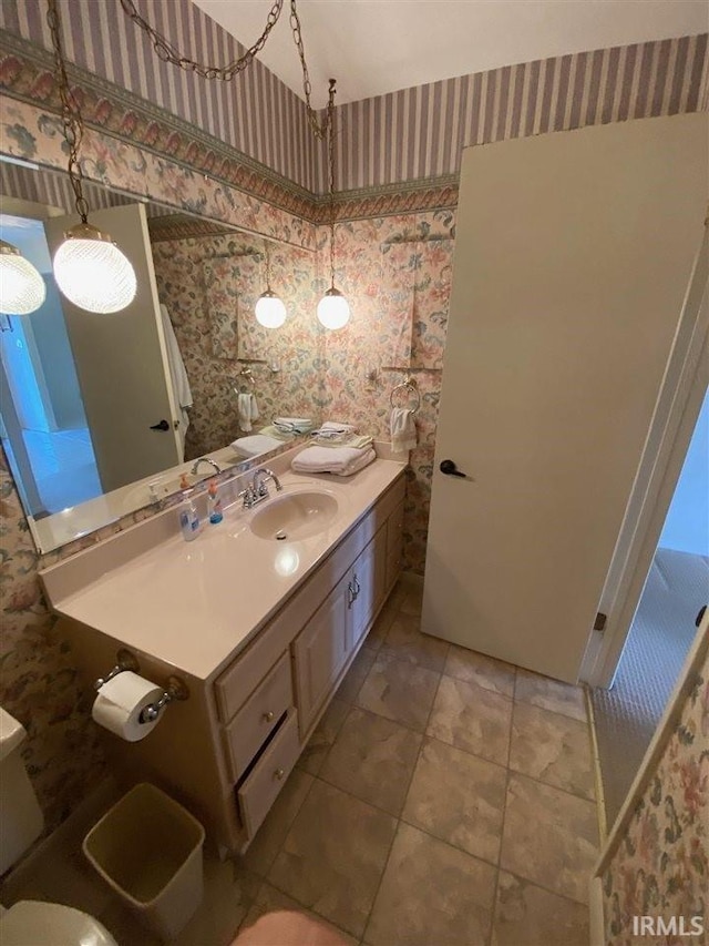 bathroom with vanity, toilet, and tile patterned flooring