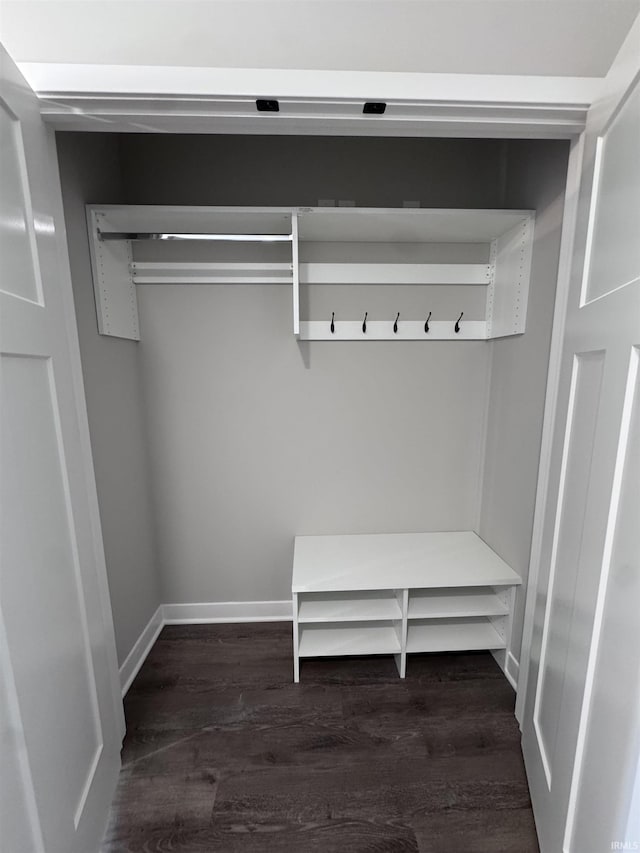 mudroom featuring baseboards and dark wood finished floors