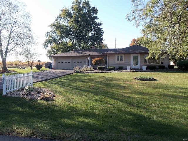 ranch-style home with a front lawn and a garage