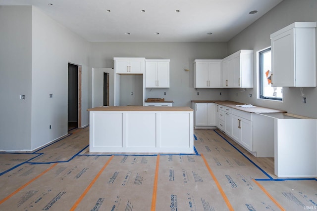 18609 Bracken Fern Ct, South Bend, IN 46637 - kitchen featuring a kitchen island and white cabinetry