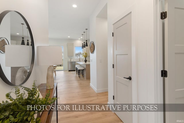 hallway with light hardwood / wood-style floors