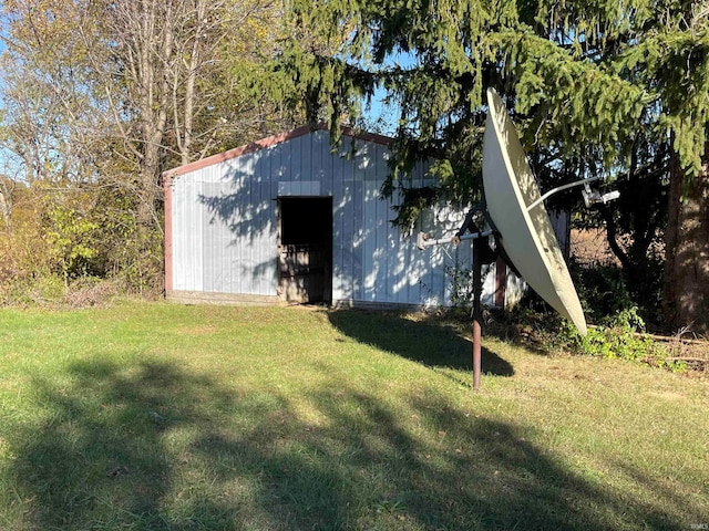 view of outbuilding featuring a yard