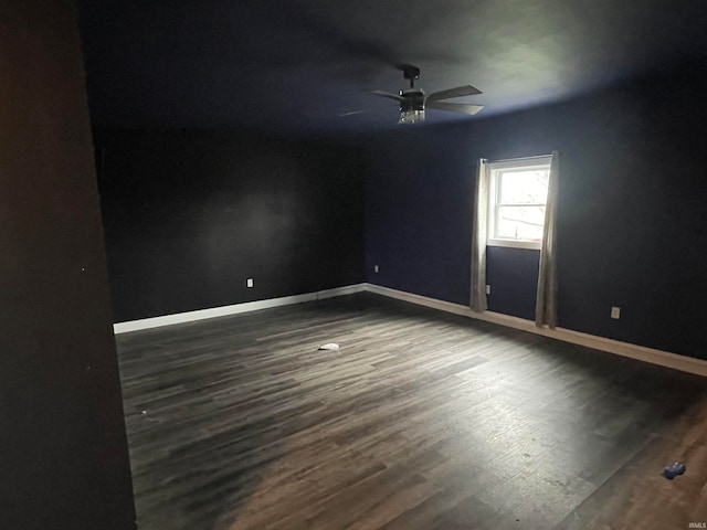 spare room with ceiling fan and dark hardwood / wood-style floors