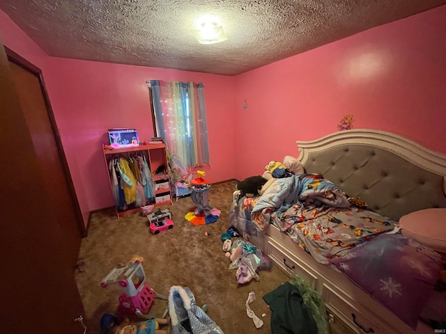 bedroom featuring a textured ceiling and carpet flooring