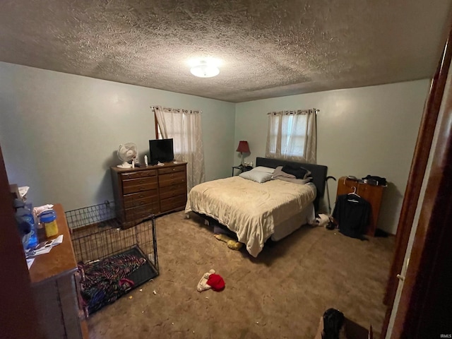 carpeted bedroom featuring a textured ceiling