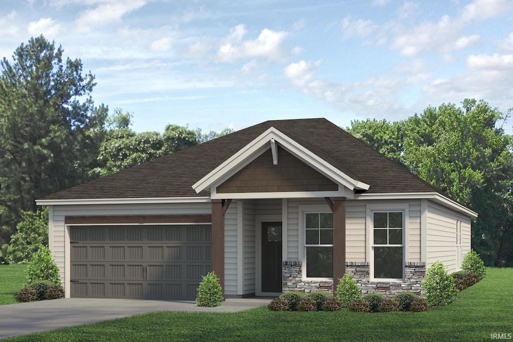 view of front of home with a garage and a front lawn