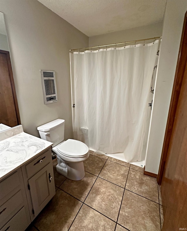 bathroom featuring a textured ceiling, walk in shower, toilet, vanity, and tile patterned flooring