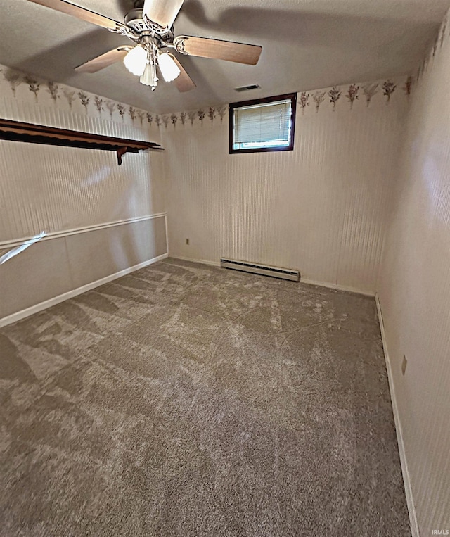 carpeted spare room featuring ceiling fan and a baseboard radiator