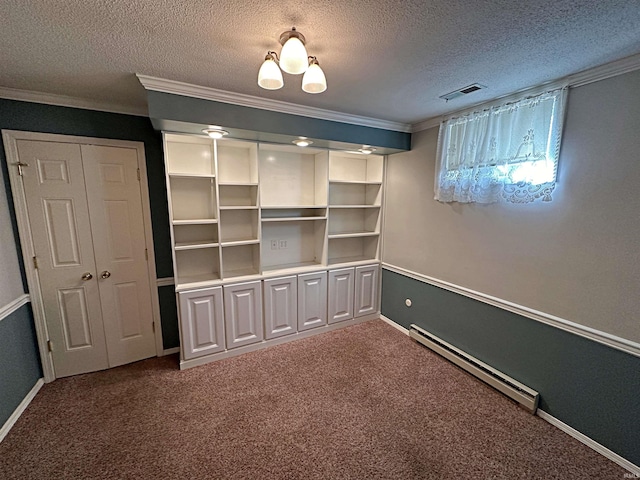 unfurnished bedroom featuring ornamental molding, a baseboard heating unit, a textured ceiling, and carpet