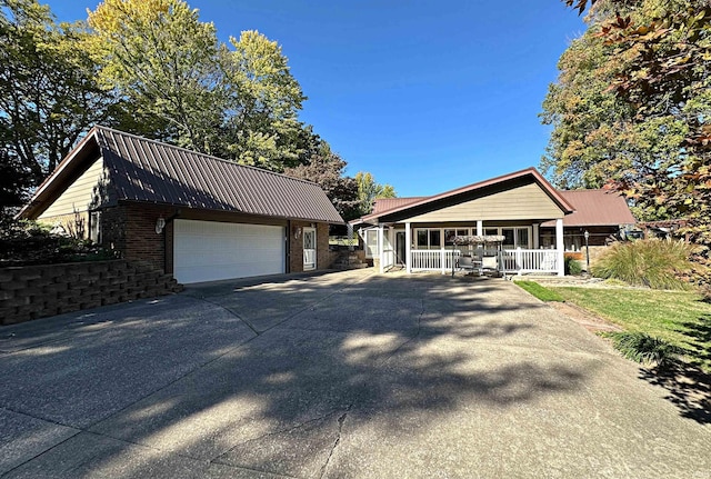 view of front facade featuring a porch and a garage