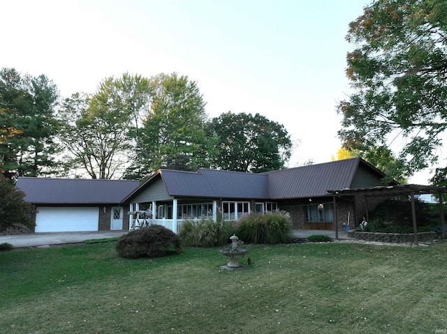 single story home with a garage and a front lawn