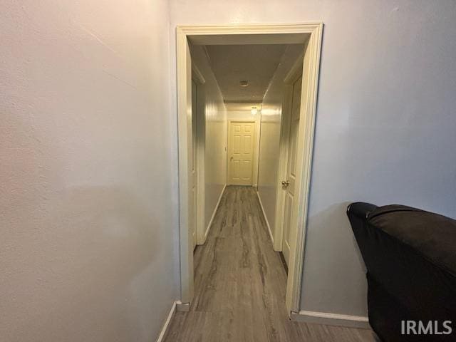 corridor with light hardwood / wood-style flooring