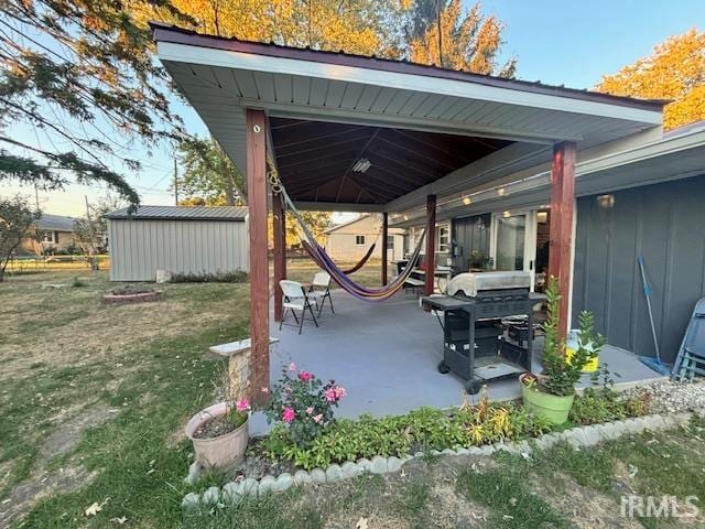 view of patio featuring a storage shed and area for grilling