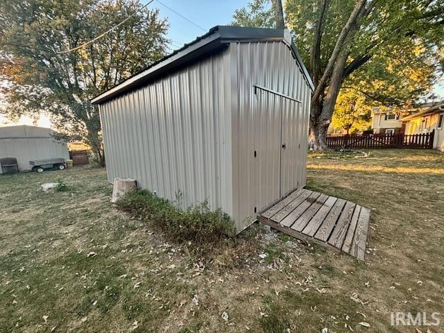 view of outbuilding featuring a lawn