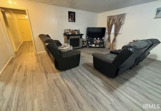 living room with ornamental molding and light wood-type flooring