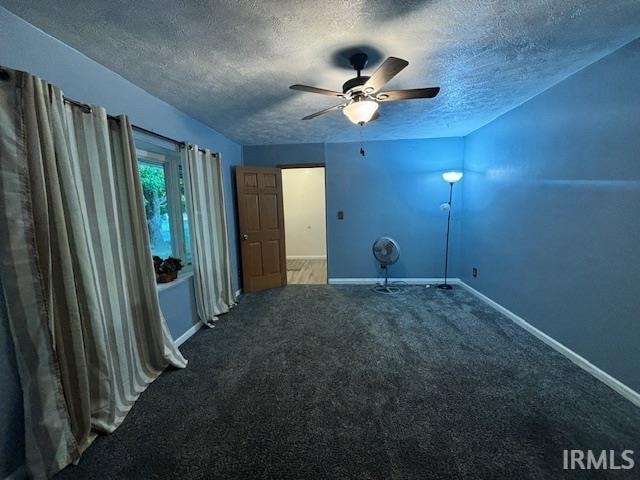 unfurnished room with carpet floors, a textured ceiling, and ceiling fan