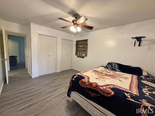 bedroom with hardwood / wood-style flooring and ceiling fan