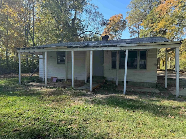 rear view of property featuring a yard