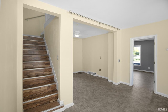 staircase with carpet floors and ceiling fan