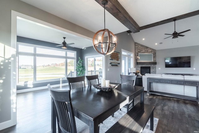 dining room featuring a notable chandelier, dark hardwood / wood-style floors, lofted ceiling with beams, and a fireplace