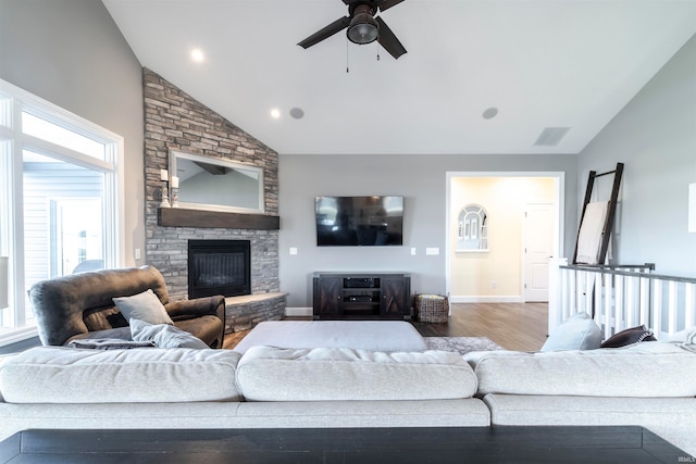 living room with hardwood / wood-style floors, a fireplace, high vaulted ceiling, and ceiling fan